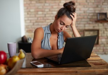 Sad woman using laptop