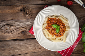 Penne a bolognese on white plate.