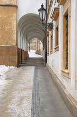 Narrow arched passage towards historical courtyard at old town,