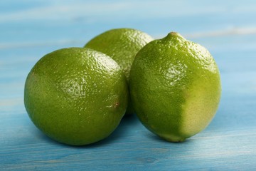 limes on a wooden background