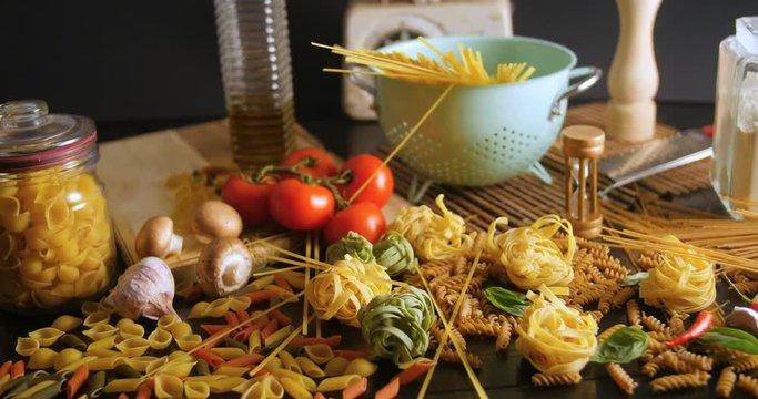 Dolly view of different variety of Italian pasta and ingredients