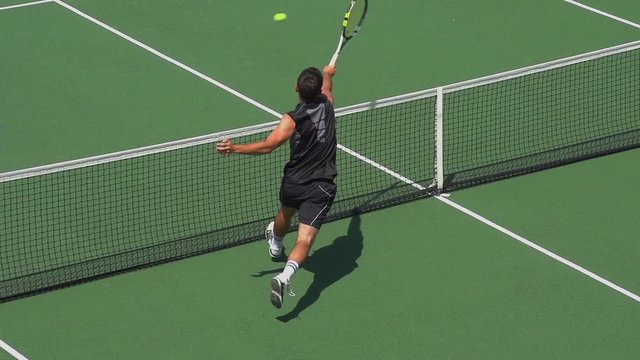 Tennis Player Volley's at net and turns to celebrate his success.
