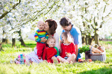 Fototapeta premium Family with kids on picnic in spring garden