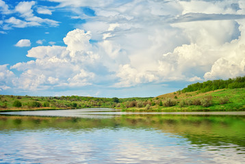 Fototapeta na wymiar Lake, River and spring green hills.
