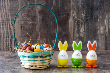 Easter eggs and rabbits on wooden table

