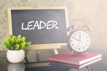 Leader on blackboard with clock and flare