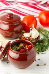 Stewed red beans with tomatoes and garlic in a ceramic pot. Vegetarian dish. Selective focus
