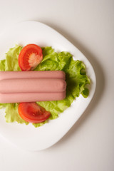 sausages with vegetables on a white background