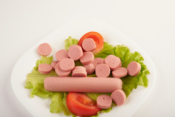 sausages with vegetables on a white background
