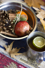 A nice autumn composition with leaves and some mix of autumn fruits together with cinnamon sticks.