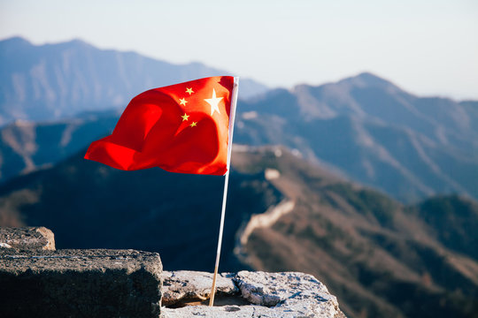 Fototapeta China flag waving over The Great Wall of China in the background