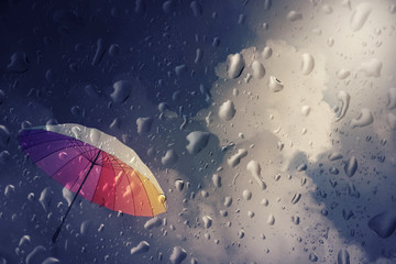 Blurry of umbrella ,view through the window on rainy day.