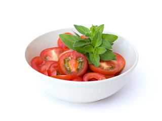 tomatoes in a bowl on a white background