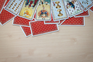 Tarot cards on wooden background.