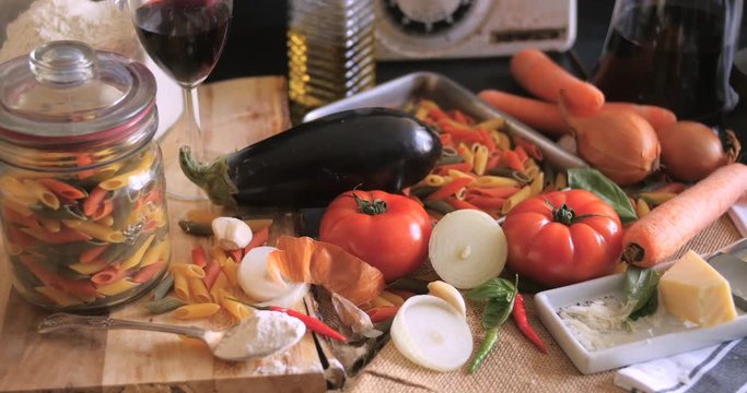 Dolly sliding view of  Italian pasta and ingredients for tomato sauce