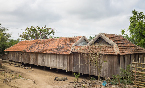 Typical Ede long house (nha dai) in central highland of Vietnam. It reflects the Ede culture of Vietnam&rsquo;s central highland region, where people of several generations gather around a charcoal fire