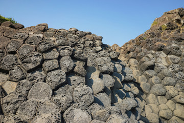 The Cliff of Stone Plates Da Dia (Ghenh Da Dia) in Central Vietnam, seashore area of uniformly interlocking basalt rock columns, created from volcanic eruptions millions of years ago