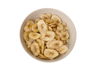 Dried bananas in a bowl on a white background