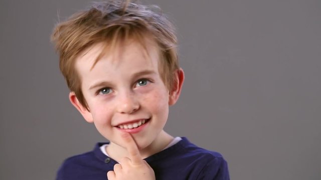 expressive smiling child with a smart reflection body language thinking