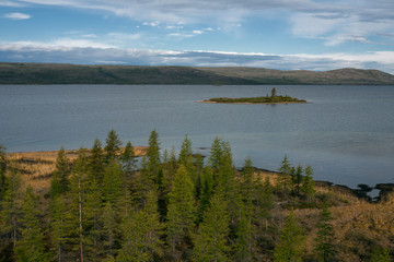 View from the shore of the lake with an island. Lake Labynkyr. Yakutia. Russia.