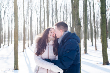 young loving couple having fun in snowy park
