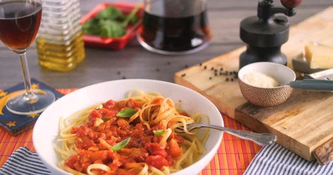 Dolly sliding view of  Italian pasta (spaghetti, linguini) with tomato sauce