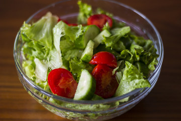 Green healthy salad with little tomatoes and salad leaves.