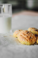cookies and milk are on a white tablecloth
