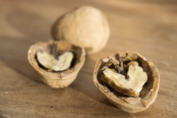 wlanuts cut in half on a wooden table