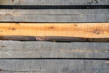 Wooden planks. Focus on yellow one