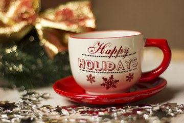 A beautiful christmas spirit background composition with a coffee -sup and jingle bells.