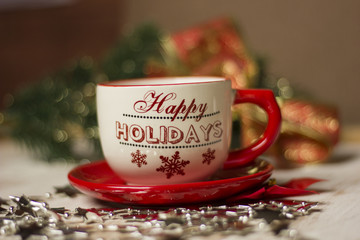 A beautiful christmas spirit background composition with a coffee -sup and jingle bells.