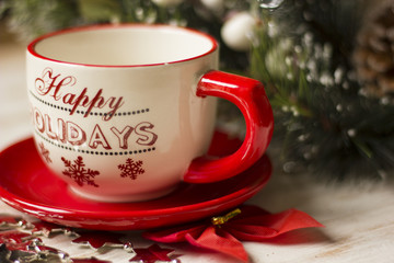 A beautiful christmas spirit background composition with a coffee -sup and jingle bells.