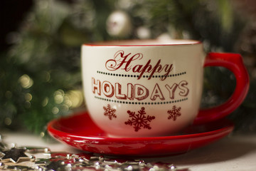 A beautiful christmas spirit background composition with a coffee -sup and jingle bells.