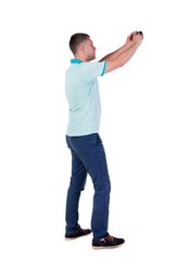 Back view of man photographing. tourist with camera.