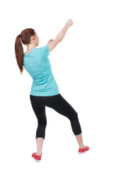 back view of woman in sportswear pulling a rope from the top or