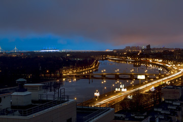 Fototapeta na wymiar The view from the heights on the river Neva in the evening ligh