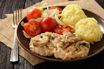 Grilled pork tenderloin with bechamel sauce, mushrooms and mashed potatoes.