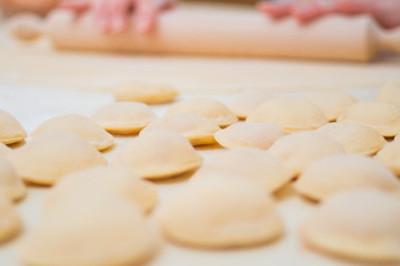 Fototapeta na wymiar Process of making ravioli, pelmeni or dumplings with meat on woo