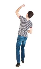 Back view of  man.  Raised his fist up in victory sign.