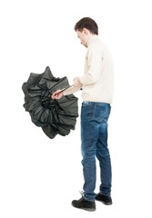 Back view of man in jeans  with umbrella.