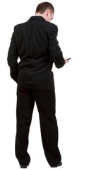  Rear view of business man in black suit  talking on mobile phon