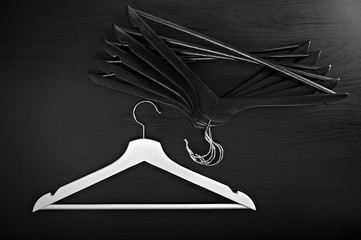 White hanger and a few black hangers, background, abstract