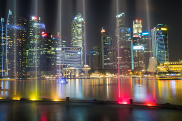 Financial and business buildings at Marina Bay with music and light show on foreground