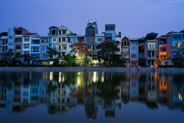 Fototapeta na wymiar Houses with reflection at twilight in Hanoi, Vietnam