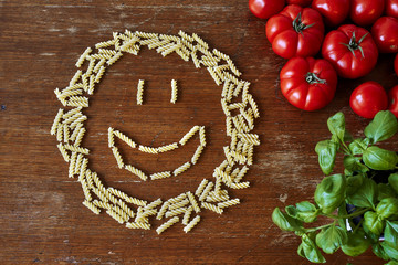 a bunch of pasta tomatoes and herbs giving space