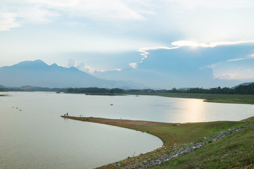 Landscape in sunset with land strip jutting out to river