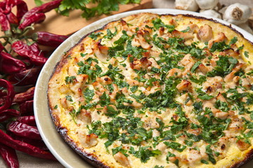 Quiche with chicken, onions, sprinkled  parsley.