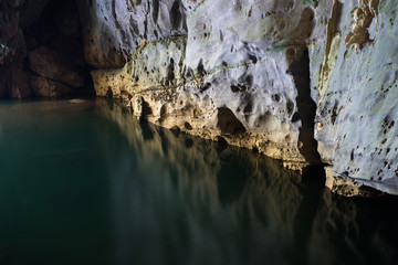River and rock cliff inside of Phong Nha Cave in Phong Nha-Ke Bang National Park, a UNESCO World Heritage Site in Quang Binh Province, Vietnam