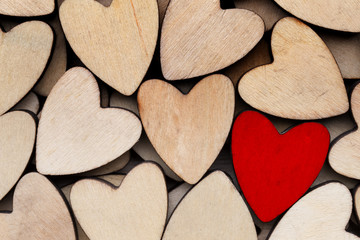 Obraz premium Wooden hearts, one red heart on the heart background.